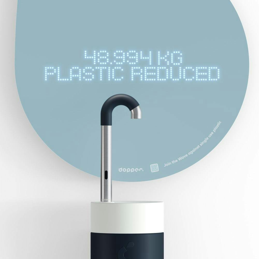 A blue Dopper Water Tap with the light blue droplet reading the number of KG of plastic is reduced